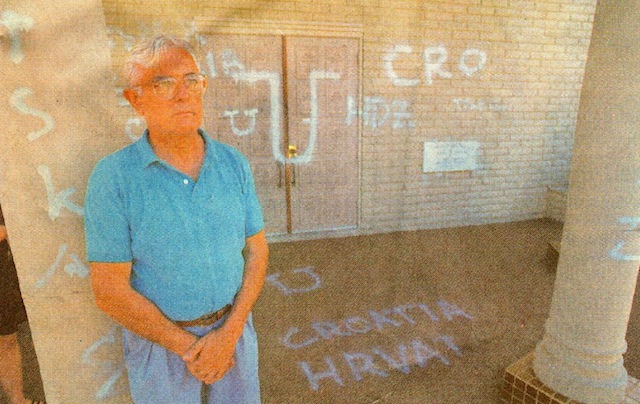 Vlado Brodich, president of the board of directors at St. Sava Serbian Orthodox Church, near 44th and McKinley streets, found Croatian profanities spray-painted on the church Friday morning. (Michael Ging/Staff photographer)