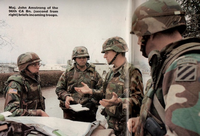 Maj. John Armstrong of the 96th CA Bn. (second from right) briefs incoming troops.