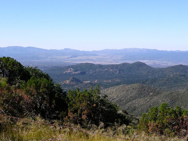 Looking south across Copper Basin to Peeples Valley. Antelope Peak is the flat spot left of the pass (in the middle); Yarnell Hill the mass to the right of the pass.