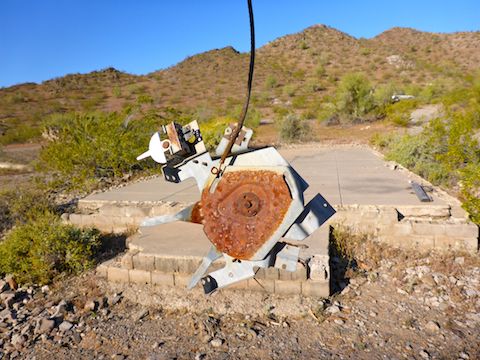 This "artifact" looks like an old turntable. The largest bulilding in the ghost town in the background.