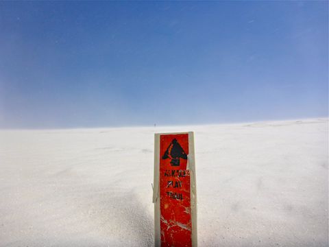 This guide pole is nearly buried by sand. Can you spot the next pole?