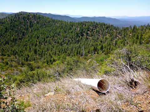 This PVC pipe served as a sluice / ore chute for wildcatters back in the 1970s. Williams Peak on the far side of the canyon.