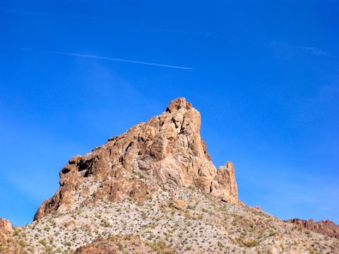 One of many awesome rock formations in the Kofa Mountains. Heavy high flying, contrail generating, passenger jet traffic overhead.