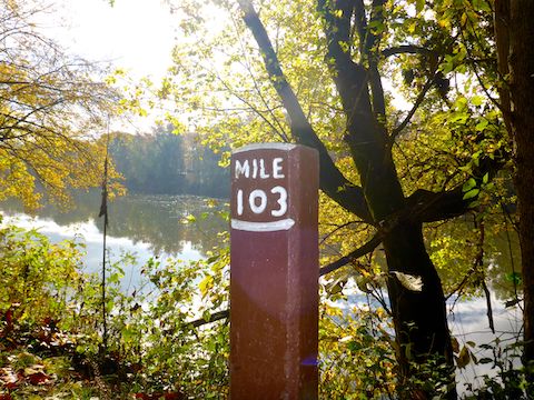 C&O Canal mileposts are actual physical objects, wooden posts about 18″ tall, painted white on brown, e.g. “Mile 103”.