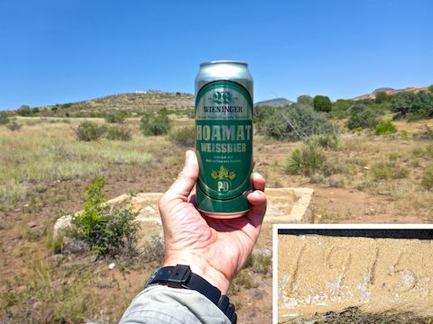 At the 1915 spring box in Racetrack Wash. Note the solar array on top of the hill. It was 98℉ when I finished my hike, so I really wished this hiking beer was simply water.