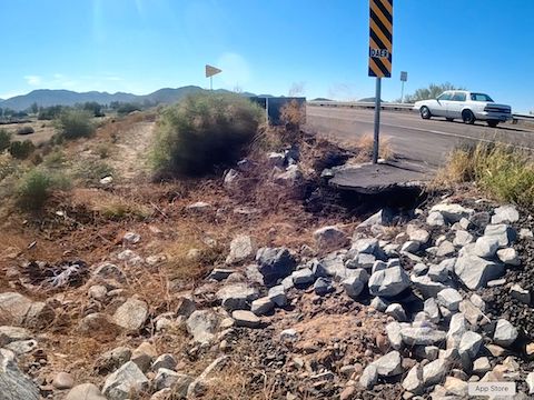Transitioning from the Estrella Pkwy. shoulder to the Gila River bridge walkway, I crashed on those rocks. Nothing broken, other than my left shift / brake handle. (GoPro screen cap)