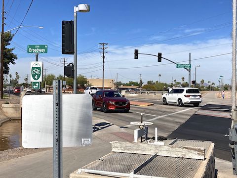 Signalled & protected crossing at Broadway Rd. Signs indicate the Mesa bike route number.