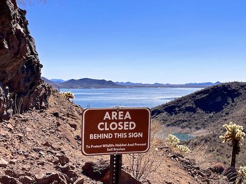 Bah! Yavapai Point Trail pitches up from this sign, climbing 180 ft. in the final 0.3 miles. Black Mountain in the distance.