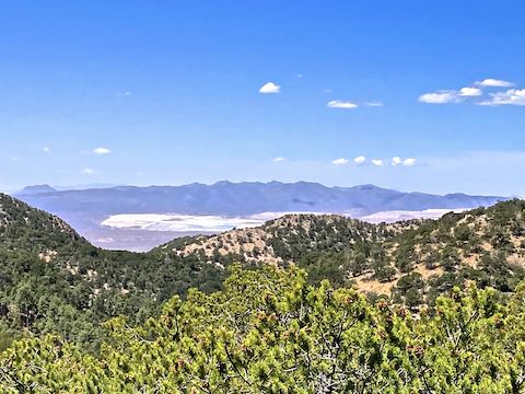 Morenci Mine, 20 miles west, is visible from Black Jack Trail #568. I believe the distant left formation is Bryce Mountain.