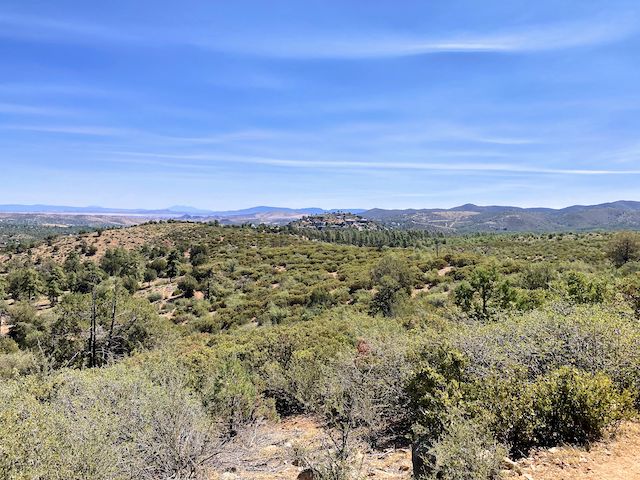 Looking northeast, across the Indian Fire burn scar, towards Cathedral Pines / Kuhne Hill. Glassford Hill, 8 miles away, is the barren formation just left of Kuhne Hill. Left of Glassford Hill, the San Francisco Peaks are just visible 74 miles away. Kendrick Peak and Bill Williams Mountain were also visible.