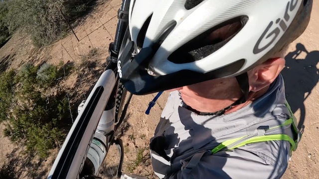 Butterfield Stage Trail: Couldn't find a gap in the landfill fence. I heaved my bike over, then low crawled under. (GoPro screen cap)