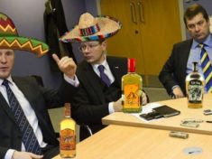 Stewart Regan & Neil Doncaster wearing sombreros and drinking tequila.