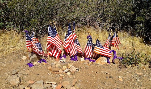 19 flags and a fire truck for he fallen Granite Mountain Hotshots.
