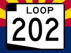 Loop 202 South Mountain Freeway sign on Arizona flag backgroound.