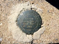 Pioneer Pass benchmark is cemented in the curb of the cattle guard. Any idea what "13 JDB" means?