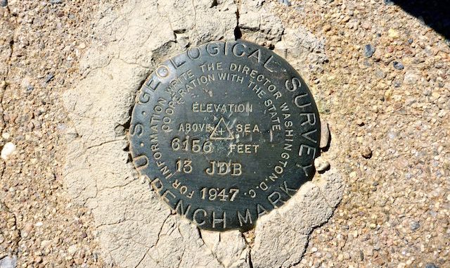 Pioneer Pass benchmark is cemented in the curb of the cattle guard. Any idea what "13 JDB" means?