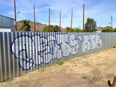 Throwup on wall of shady used car lot in Sunnyslope.