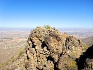 Two outcroppings form the summit of Maricopa Peak. I am on the lower outcropping, looking northeast at the actual summit. The short scramble to the top is either side of the dark rock with graffiti on it.