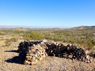 Stone X at the east end of Gadsden Trail. The stone X overlooks Desert Rose Trail, which ends at Phoenix International Raceway (PIR), barely visible past that small hill in the middle.