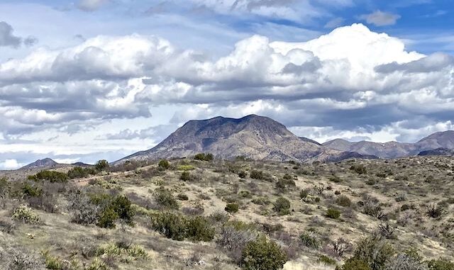 Clouds rolling in over Stanley Butte, seven miles northeast, just inside the San Carlos Apache Reservation.