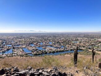 Arrowhead Lakes, as viewed from the summit of Arrowhead Point. Sierra Estrella peaking through the I-10 smog, 25 miles away. Coachwhip Trail traverses the area below the lakes.