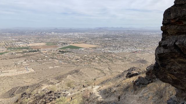 Looking down Hau'Pal Loop, and across Phoenix, to (left-to-right) Shaw Butte, North Mountain, Piestewa Peak, Mummy Mountain, Camelback Mountain and Papago Buttes. Most of the 1,000 ft. Hau'Pal Loop climb is visible.