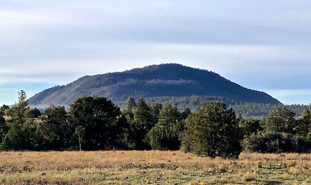 Apache Maid Mountain looks like a layer cake. Note the fire smoke on the left.